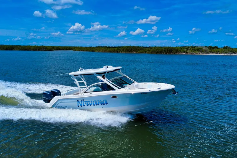 Slide: The Image of 2019 Robalo R317 Dual Console boat cruising on a sunny day. - 5