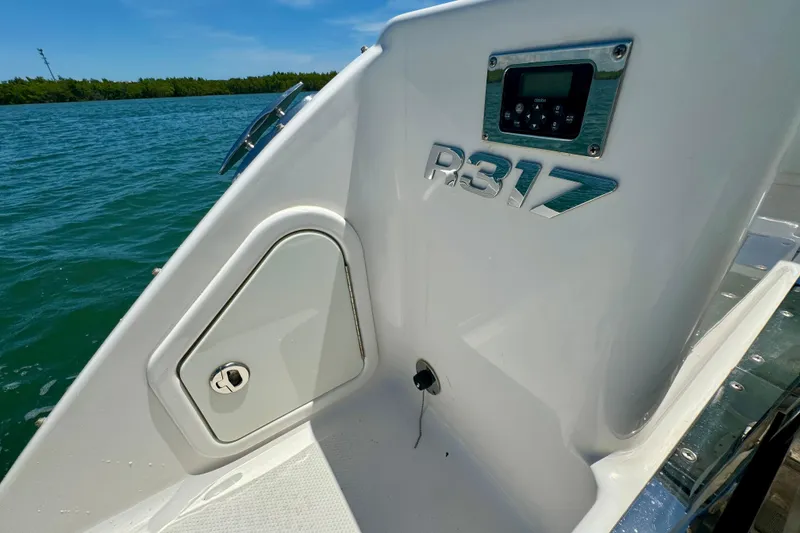 Slide: The Image of 2019 Robalo R317 Dual Console boat detail with control panel, docked by the water. - 50