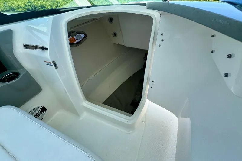 Slide: The Image of 2019 Robalo R317 Dual Console interior storage compartment with open door. - 54