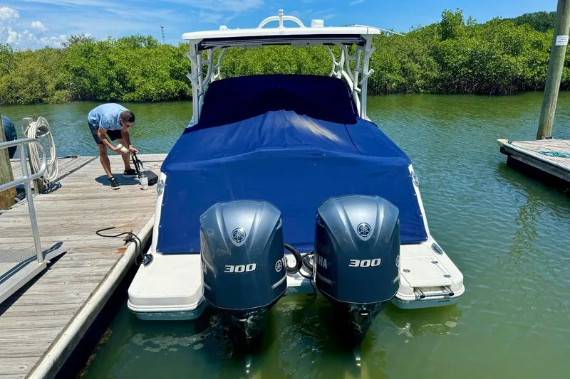 Slide: The Image of 2019 Robalo R317 Dual Console boat docked with twin Yamaha 300 engines. - 56