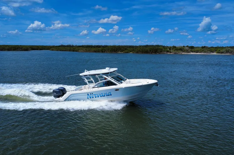Slide: The Image of 2019 Robalo R317 Dual Console boat cruising on a sunny day. - 6