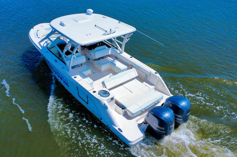 Slide: The Image of 2019 Robalo R317 Dual Console boat cruising on open water. - 8