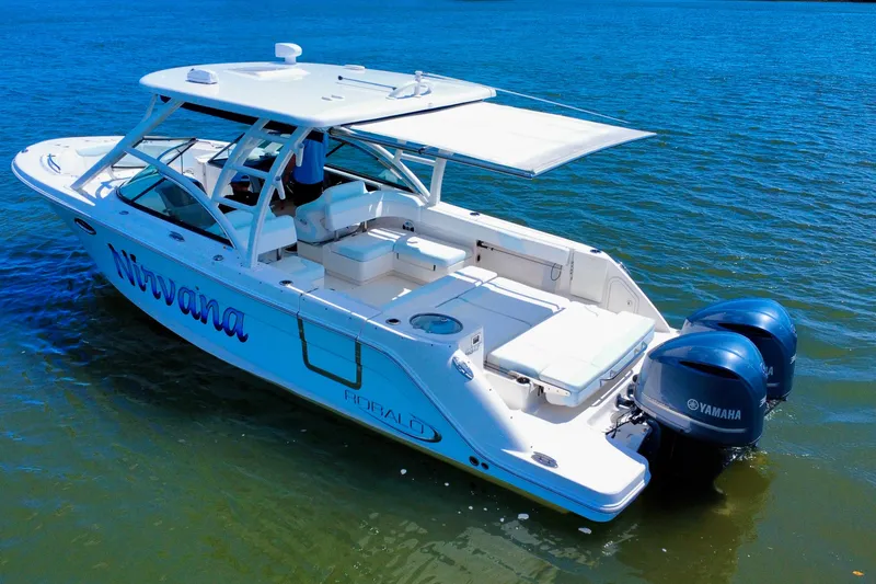 Slide: The Image of 2019 Robalo R317 Dual Console boat on water, featuring Yamaha engines and a spacious deck. - 9