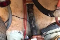 Slide: The Image of Engine compartment of a 1977 Columbia 31 sailboat with visible wiring and hoses. - 15