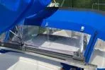 Slide: The Image of 1977 Columbia 31 sailboat with blue canopy and clear window, showcasing deck details. - 4