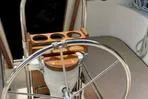 Slide: The Image of 1977 Columbia 31 sailboat helm with stainless steel wheel and wooden cup holder. - 5