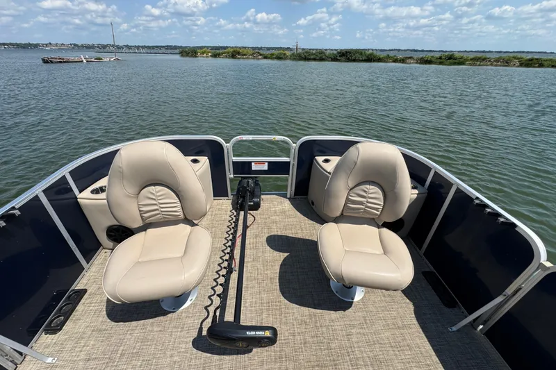 Slide: The Image of 2019 G3 X22FC boat with beige seats on a calm lake. - 10