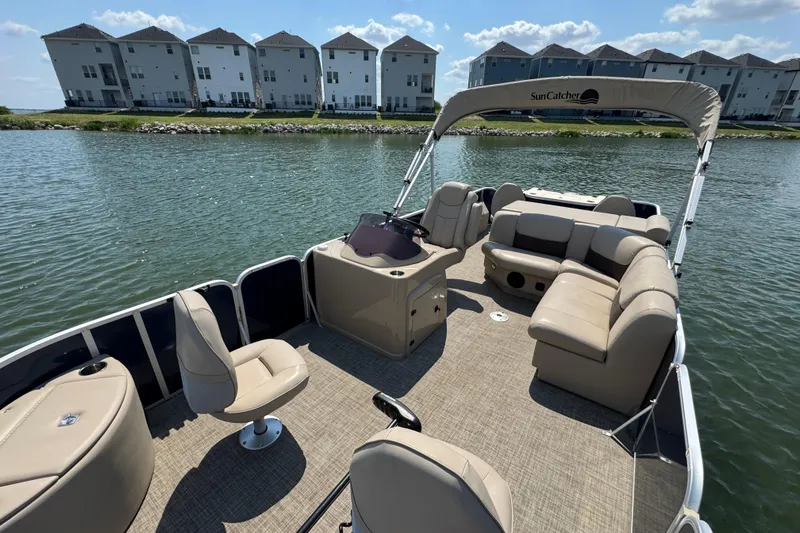 Slide: The Image of Pontoon boat G3 X22FC 2019 on a lake with modern apartments in the background. - 11