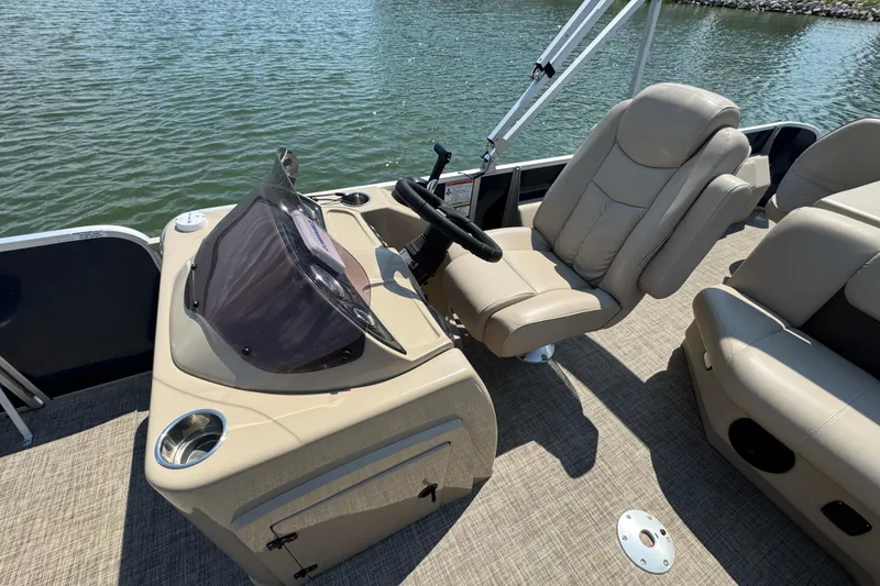 Slide: The Image of 2019 G3 X22FC boat interior with beige captain's chair and steering console. - 12