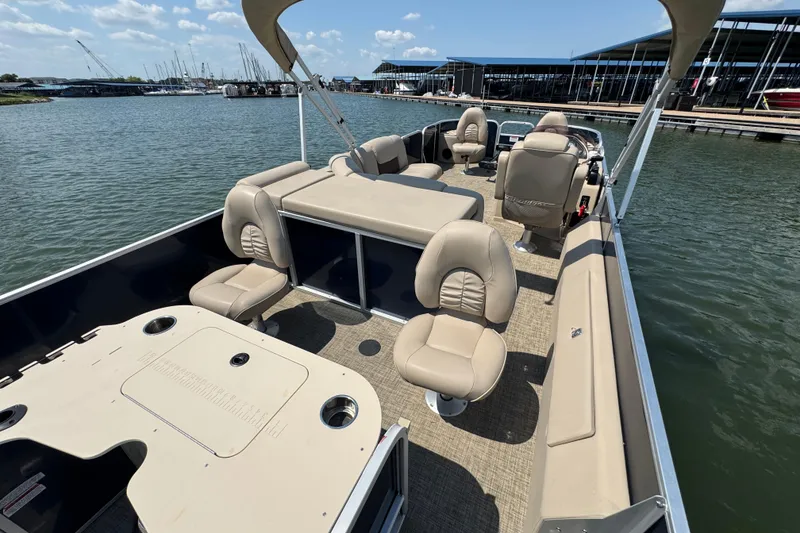 Slide: The Image of 2019 G3 X22FC pontoon boat with beige seating, docked on a sunny day. - 17