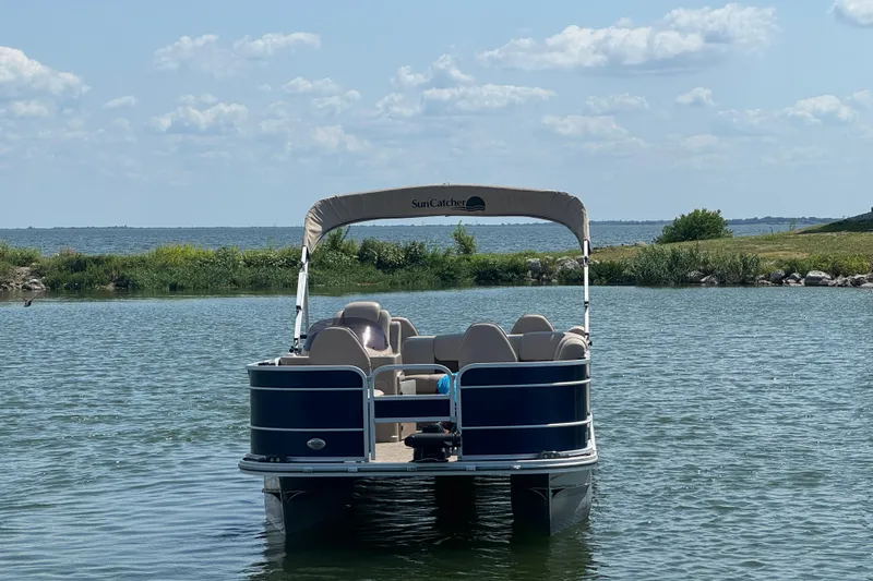 Slide: The Image of Pontoon boat G3 X22FC 2019 on a serene lake with lush greenery. - 2