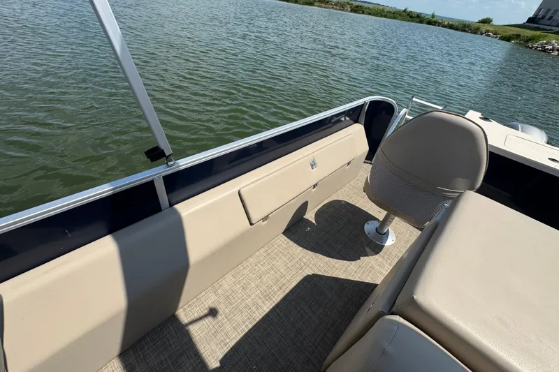 Slide: The Image of 2019 G3 X22FC boat interior with seating, on a calm lake. - 20