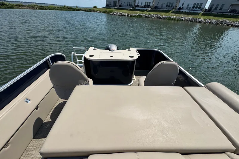 Slide: The Image of 2019 G3 X22FC boat interior with seating, on a calm lake. - 21