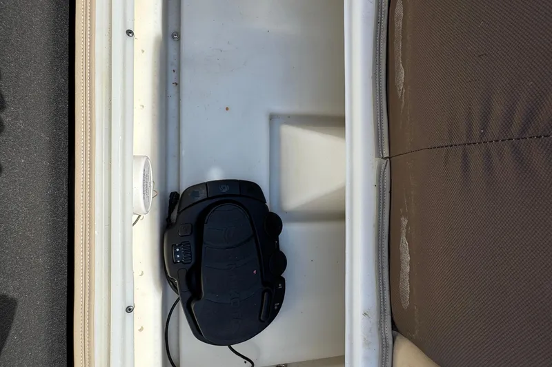 Slide: The Image of Storage compartment in a 2019 G3 X22FC boat with a black trolling motor pedal. - 24
