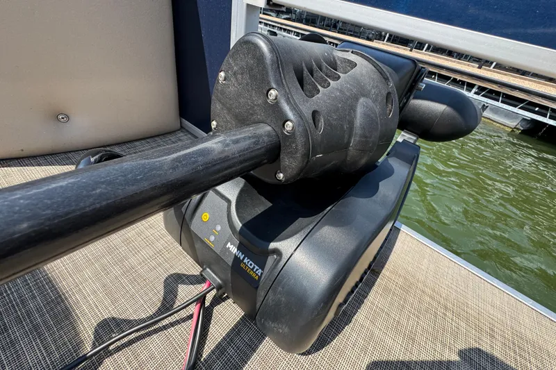 Slide: The Image of Minn Kota Ulterra motor on 2019 G3 X22FC boat, docked by water. - 25