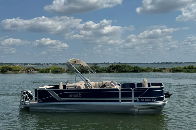 Slide: The Image of Pontoon boat G3 X22FC 2019 on a serene lake under a cloudy sky. - 3
