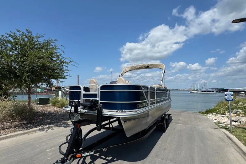 Slide: The Image of 2019 G3 X22FC pontoon boat on trailer by a lakeside under blue sky. - 6