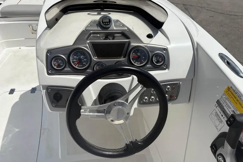 Slide: The Image of Steering console of a 2022 Tahoe 1950 boat with gauges and controls. - 8