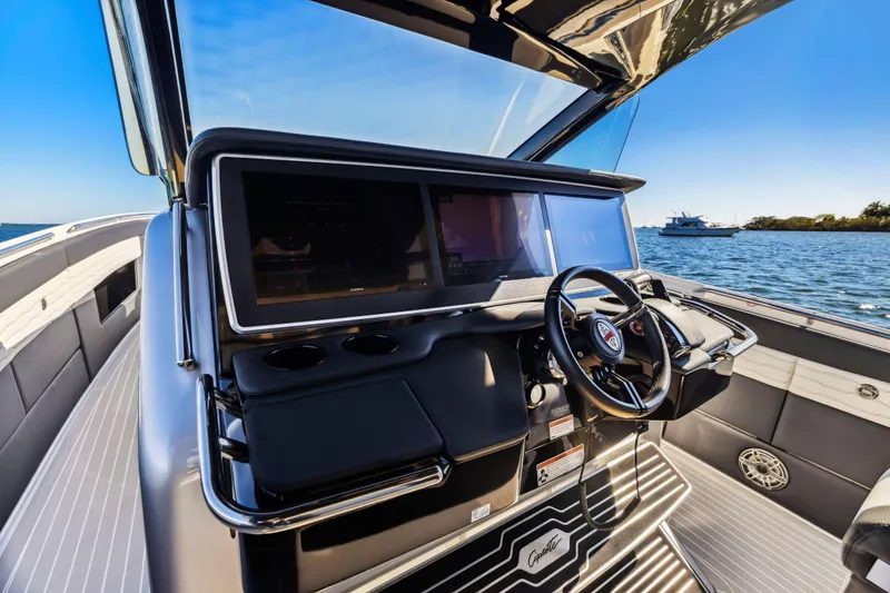 Slide: The Image of 2022 Cigarette 42 Auroris boat cockpit with modern steering and navigation system. - 11