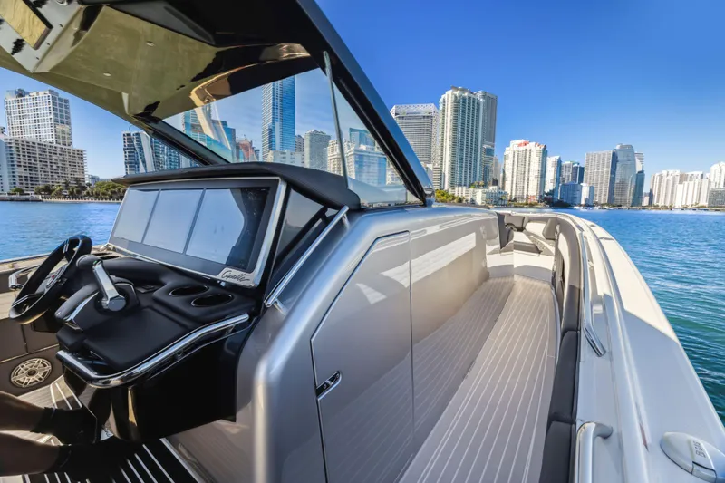 Slide: The Image of 2022 Cigarette 42 Auroris boat with sleek design, city skyline in background. - 12