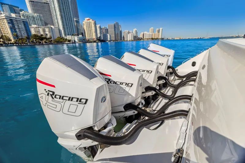 Slide: The Image of 2022 Cigarette 42 Auroris boat with four powerful outboard engines, city skyline in background. - 2