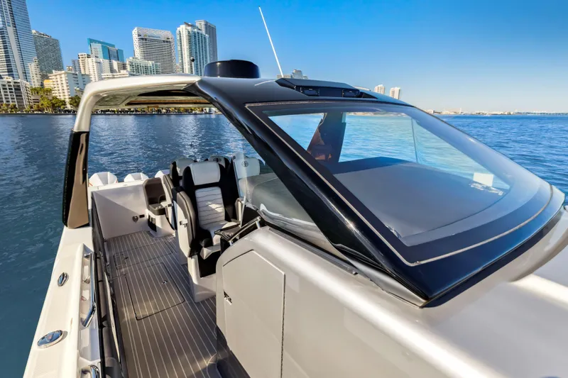 Slide: The Image of 2022 Cigarette 42 Auroris boat with sleek design, city skyline in background. - 22