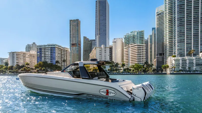 Slide: The Image of 2022 Cigarette 42 Auroris boat on water with city skyline in background. - 4