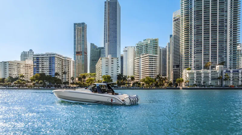 Slide: The Image of 2022 Cigarette 42 Auroris boat cruising in urban waterfront with skyscrapers in the background. - 6