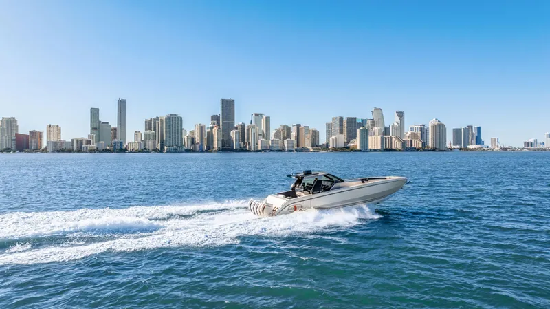 Slide: The Image of 2022 Cigarette 42 Auroris speedboat cruising near city skyline on a sunny day. - 9