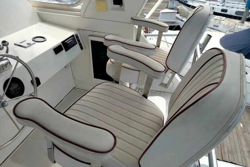 Slide: The Image of Interior of 1985 50' Pacifica Long Range Sportfisherman with white cushioned seats and steering wheel. - 11