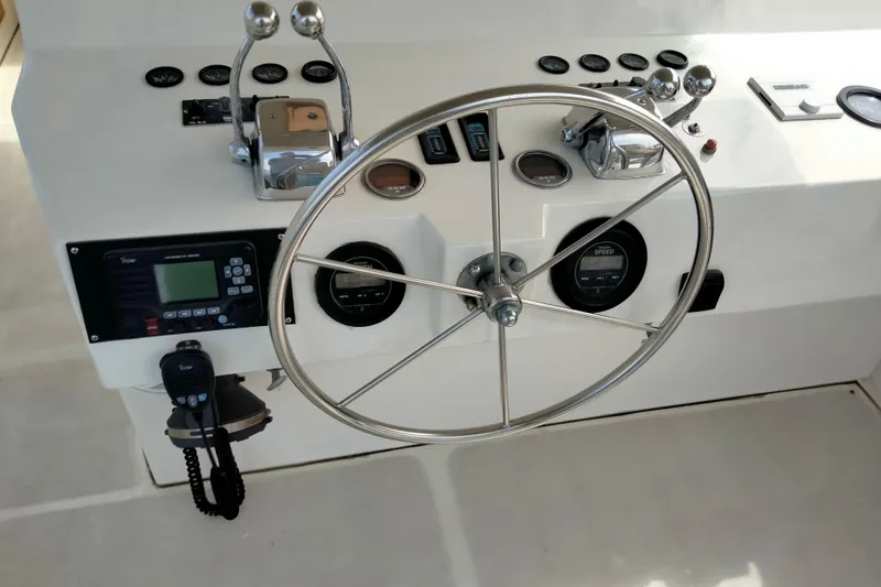 Slide: The Image of Control panel of a 1985 50' Pacifica Long Range Sportfisherman with steering wheel and gauges. - 12