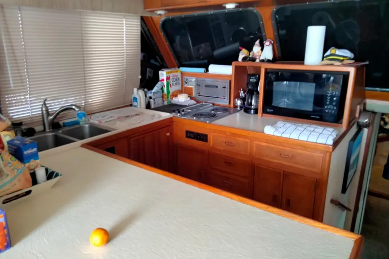 Slide: The Image of 1985 50' Pacifica Long Range Sportfisherman kitchen with microwave, coffee maker, and dual sink. - 18