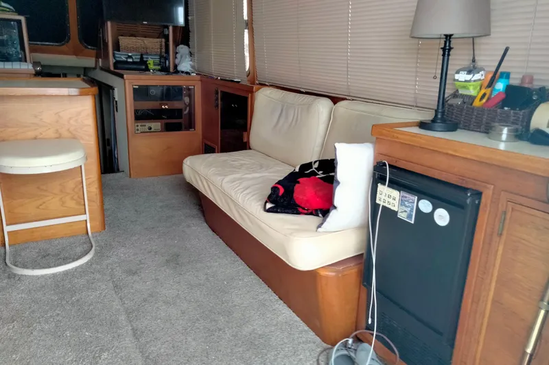 Slide: The Image of Interior of 1985 50' Pacifica Long Range Sportfisherman with cozy seating and wooden cabinetry. - 22