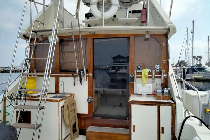 Slide: The Image of 1985 50' Pacifica Long Range Sportfisherman boat interior with ladder and marina view. - 3