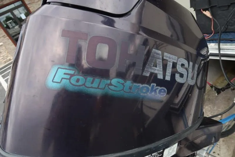 Slide: The Image of Tohatsu FourStroke outboard motor, close-up view, showcasing brand logo and design. - 10