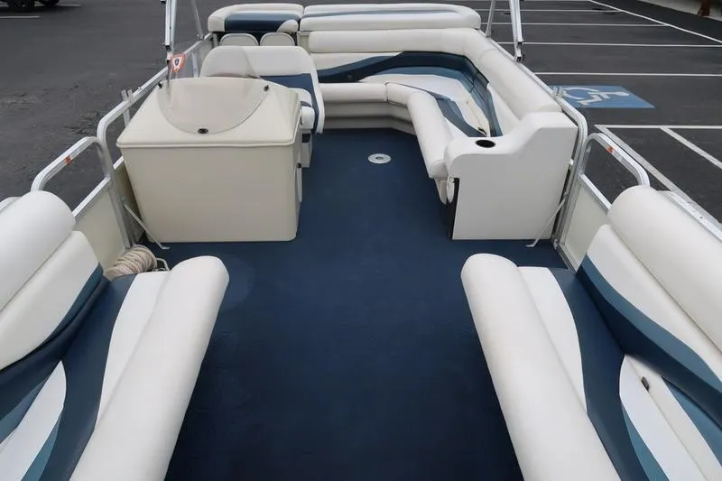 Slide: The Image of 2002 Lowe Trinidad 200 pontoon boat interior with white and blue seating. - 14