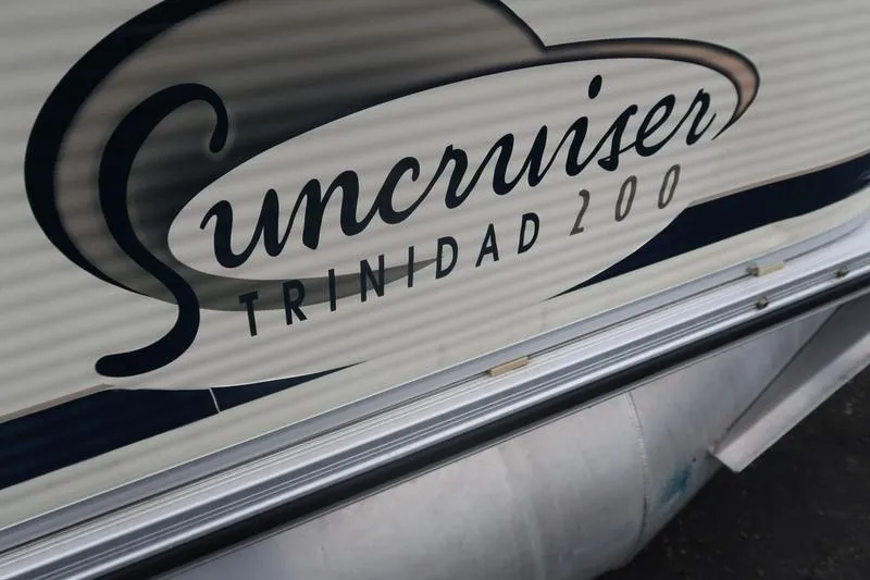 Slide: The Image of Close-up of a 2002 Lowe Trinidad 200 Suncruiser logo on a boat's side. - 15