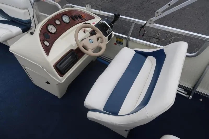 Slide: The Image of Lowe Trinadad 200 boat interior, 2002 model, featuring steering console and cushioned seating. - 18