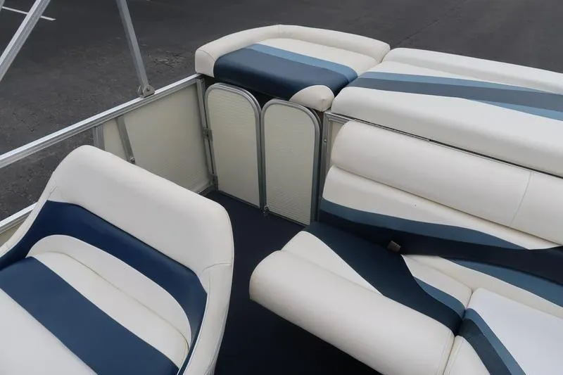 Slide: The Image of Interior of a 2002 Lowe Trinidad 200 boat with white and blue seating. - 19