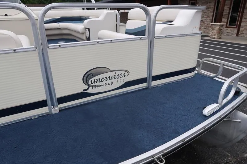 Slide: The Image of 2002 Lowe Trinidad 200 pontoon boat with blue carpet and white seating. - 22