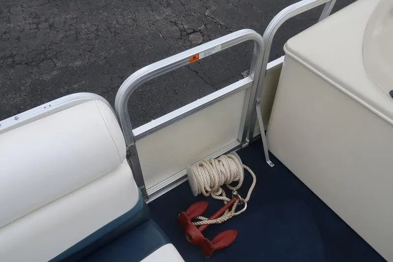 Slide: The Image of Interior of a 2002 Lowe Trinadad 200 boat with rope and anchor. - 25