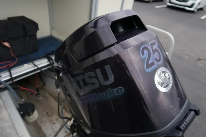 Slide: The Image of Outboard motor with "25" label on a Lowe Trinadad 200 boat, 2002 model. - 7