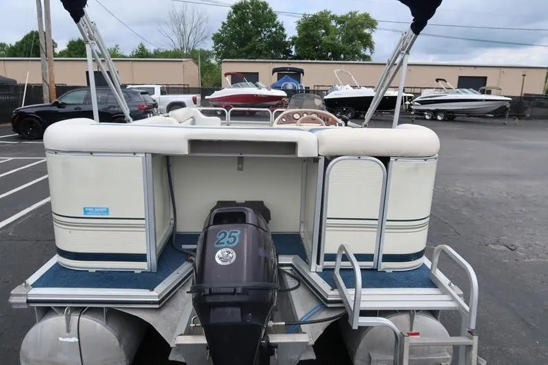 Slide: The Image of 2002 Lowe Trinidad 200 pontoon boat with 25 HP motor in a parking lot. - 8