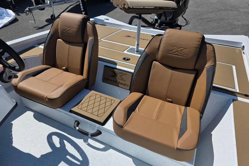 Slide: The Image of 2026 Xpress H20C Crappie boat interior with tan leather seats and steering wheel. - 20