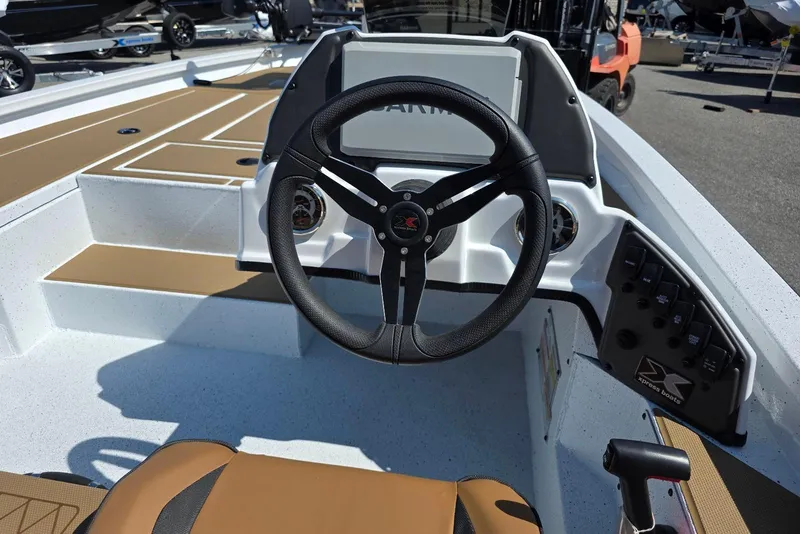 Slide: The Image of 2026 Xpress H20C Crappie boat interior with steering wheel and control panel. - 22