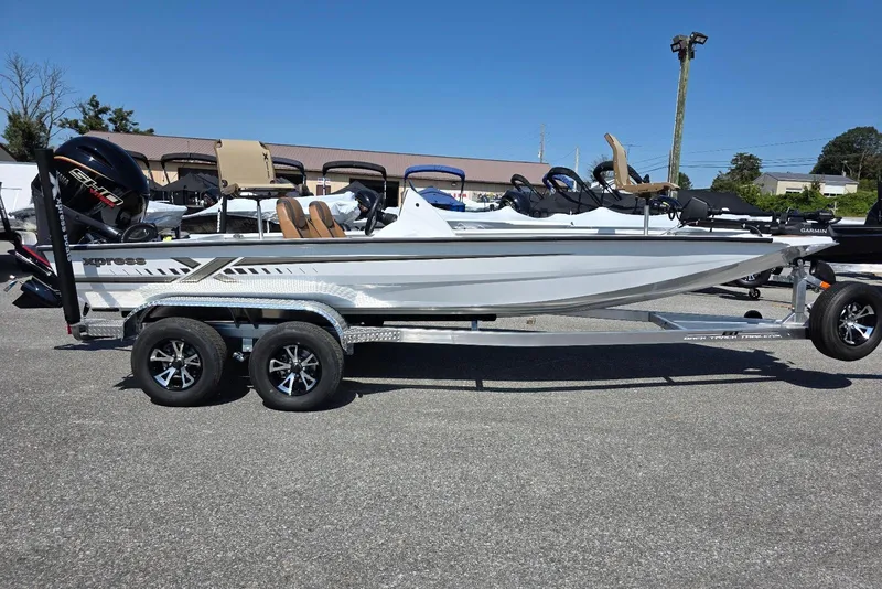 The Image of 2026 Xpress H20C Crappie boat on trailer, side view, outdoors. - 7