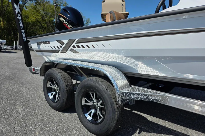 Slide: The Image of 2026 Xpress H20C Crappie boat on trailer, featuring sleek design and dual wheels. - 9