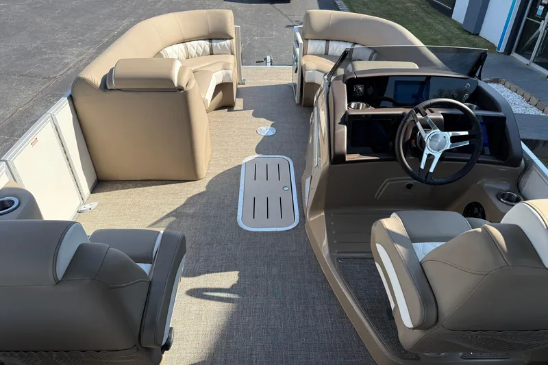 Slide: The Image of 2025 Bennington 23 LXSFB pontoon boat interior with beige seating and modern helm. - 15