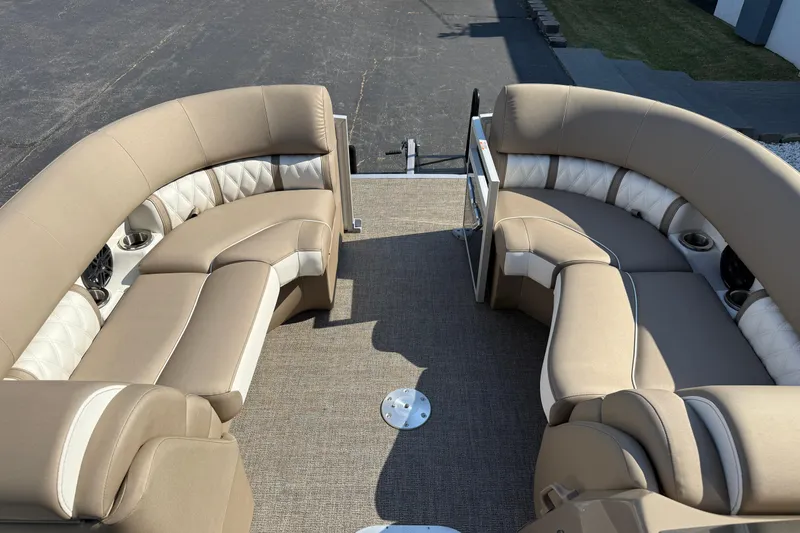 Slide: The Image of 2025 Bennington 23 LXSFB boat interior with beige seating and cup holders. - 16