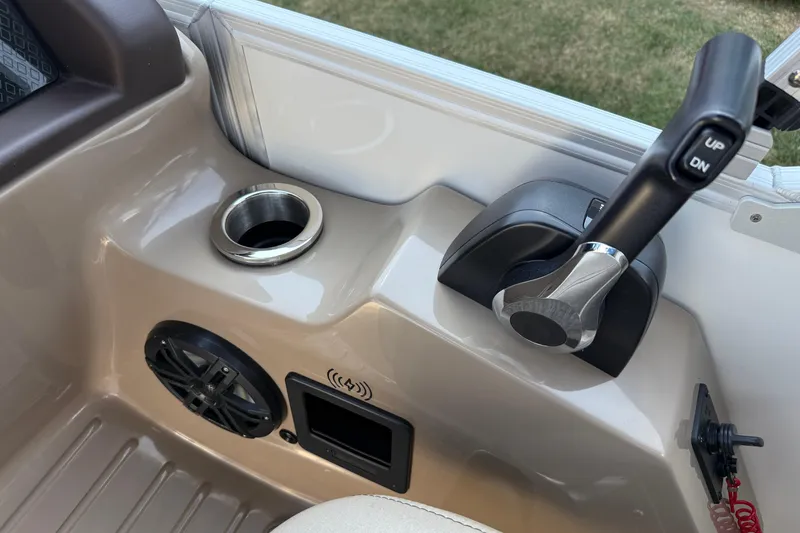 Slide: The Image of Control panel of 2025 Bennington 23 LXSFB boat with throttle, speaker, and cup holder. - 20